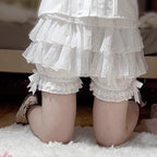 These delicate safety shorts combine functionality with Lolita aesthetics. Featuring lace-trimmed tiers and a bloomer-inspired design, they provide discreet coverage under skirts and dresses. Rendered in classic black and white, the lightweight fabric ensures comfort while adding a romantic touch to any coordination. Perfect for both sweet and Gothic styles, they offer practical elegance for dynamic wear.