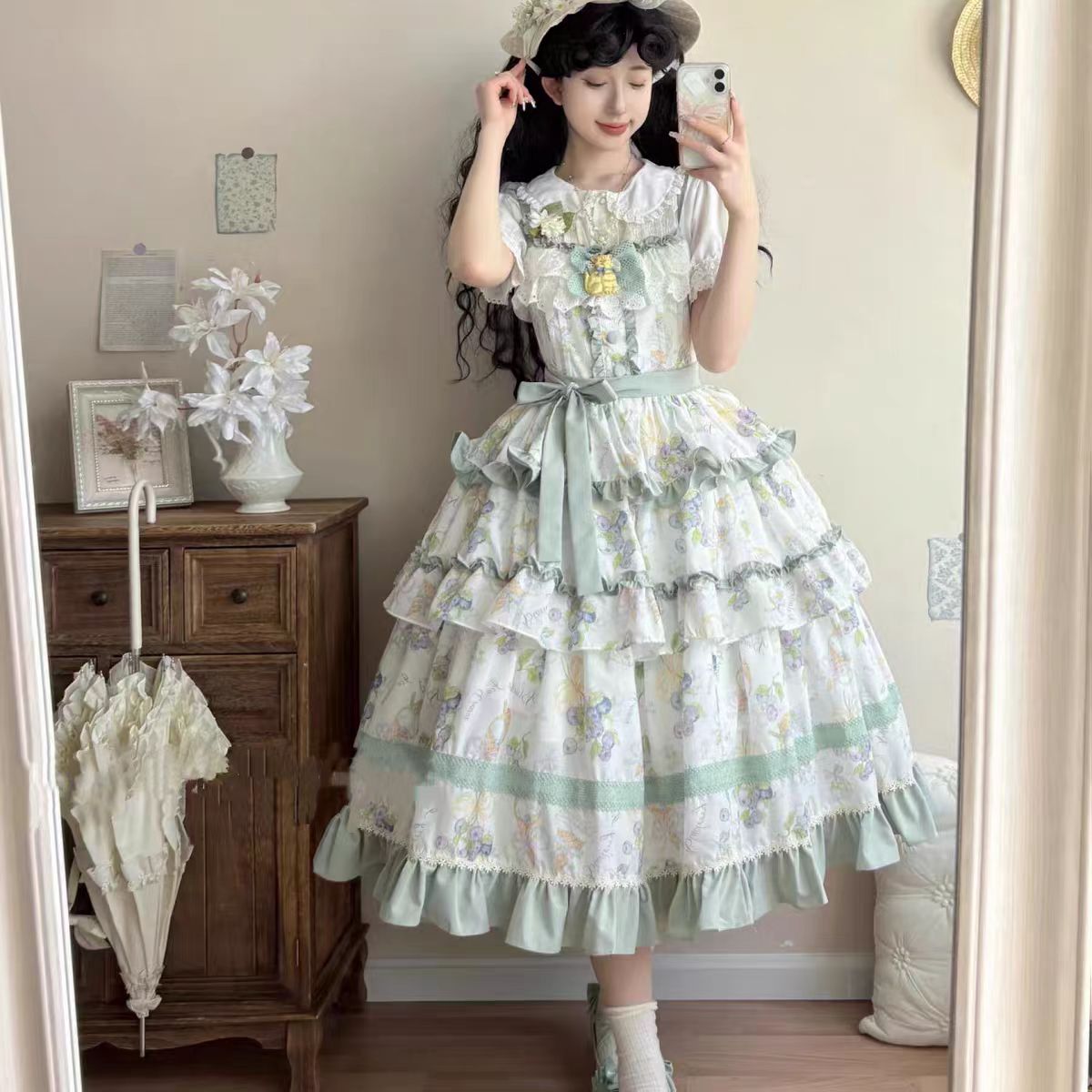 This Purple Green Classic Sweet Lolita JSK Dress is crafted to blend elegance with playful charm. The sleeveless design highlights the triple-layered ruffles and soft lace details, creating a light yet voluminous silhouette. Bowknot accents add a touch of sweetness, while the purple and green color combination offers a refreshing and unique vintage feel. Perfect for tea parties, daily outings, or themed events, this dress reflects timeless Lolita grace with a colorful twist.