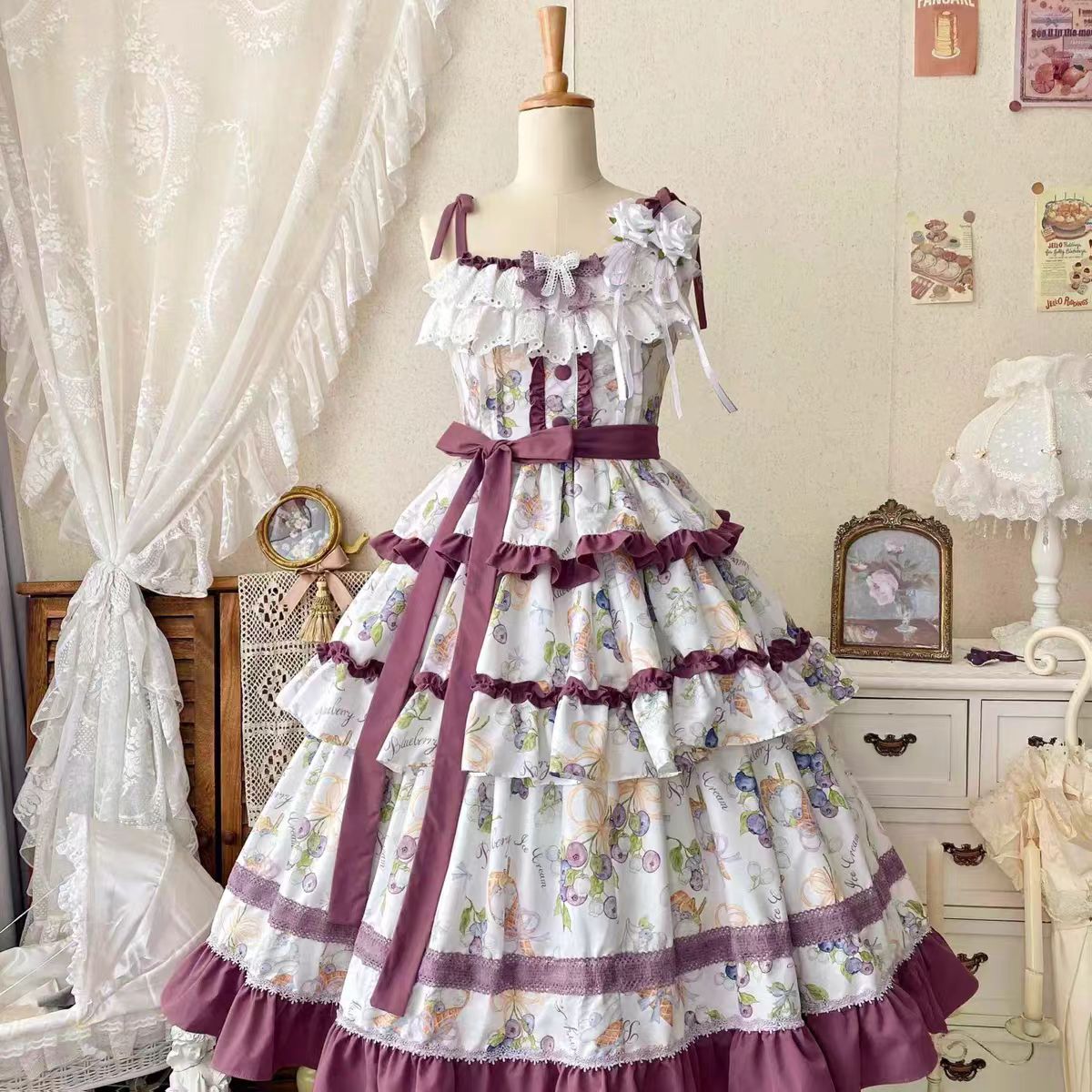 This Purple Green Classic Sweet Lolita JSK Dress is crafted to blend elegance with playful charm. The sleeveless design highlights the triple-layered ruffles and soft lace details, creating a light yet voluminous silhouette. Bowknot accents add a touch of sweetness, while the purple and green color combination offers a refreshing and unique vintage feel. Perfect for tea parties, daily outings, or themed events, this dress reflects timeless Lolita grace with a colorful twist.