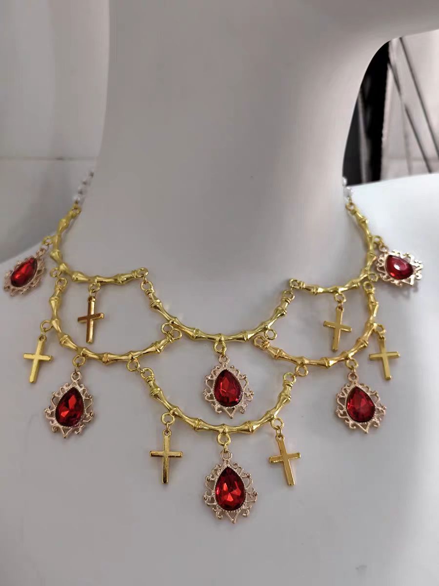 This Lolita Gold Layered Necklace embodies luxurious vintage elegance with a touch of European palace charm. Featuring multiple delicate layers, intricate cross details, and a refined gold finish, it highlights the neckline with sophistication. Perfect for tea parties, cosplay, or formal Lolita gatherings, this accessory enhances any classic or elegant outfit. Its ornate design blends traditional Gothic influences with regal Lolita aesthetics, creating a statement piece that exudes refinement and charm.