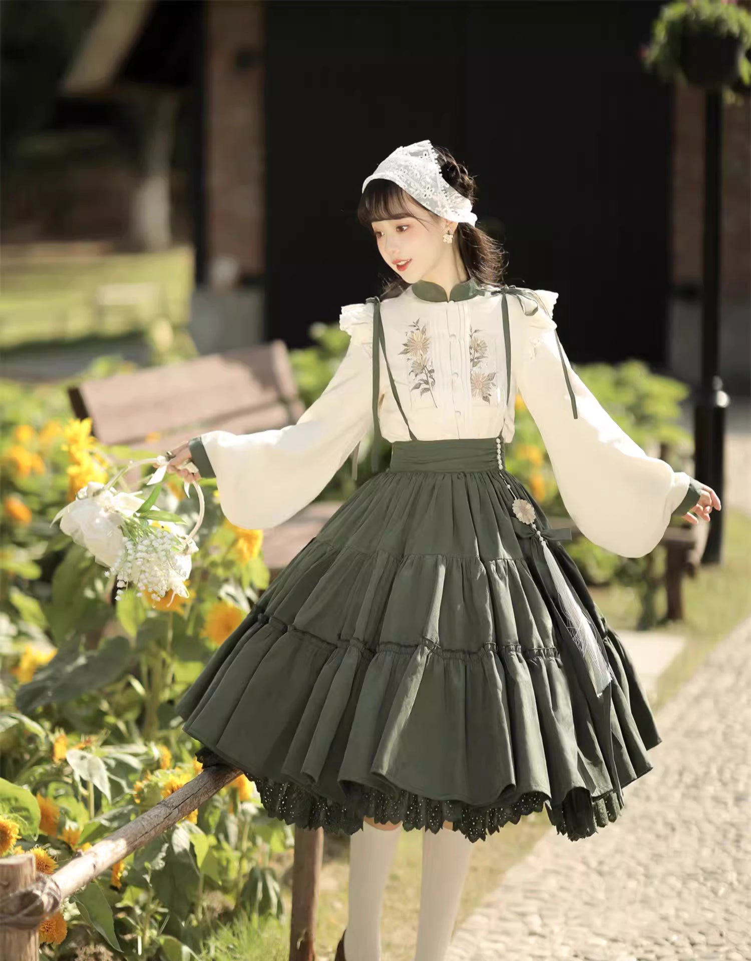 This Green Sunflower Embroidery Lolita Set blends the elegance of Hanfu-inspired details with the sweetness of classic Lolita fashion. The delicate sunflower embroidery brings a fresh pastoral charm, while the layered JSK and long-sleeve blouse create a refined silhouette. Designed for comfort and beauty, it is perfect for spring and autumn wear. Whether for tea parties, garden walks, or seasonal gatherings, this set captures a graceful harmony of tradition and modern Lolita style.