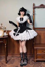 This dress dances between darkness and delight, blending Gothic subtlety with Lolita’s sweet heart. Layer upon layer of lace and ruffles create a dynamic texture, while the asymmetrical hemline adds modern whimsy to classic elegance. The delicate bow accents and sleeveless design offer versatility—perfect for layering or standing alone—inviting the wearer to embrace both mystery and innocence in a single, unforgettable silhouette.