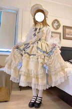 "Inspired by the opulence of royal courts and the delicate beauty of gilded artistry, this dress transforms classic Lolita elegance into a vision of luxury. The gold-toned palette evokes a sense of grandeur, while intricate lace and cascading ruffles reflect both tradition and fantasy."