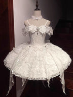 Inspired by the duality of modern femininity, this dress merges classic Lolita elegance with contemporary sophistication. The structured sweetheart bodice and voluminous skirt create a timeless silhouette, while the off-shoulder neckline adds a touch of delicate allure. Crafted in luxurious ivory with intricate lace detailing, it embodies both innocence and refinement. Ideal for moments where fantasy meets reality—perfect for the dreamer who commands grace with quiet confidence.