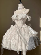Inspired by the duality of modern femininity, this dress merges classic Lolita elegance with contemporary sophistication. The structured sweetheart bodice and voluminous skirt create a timeless silhouette, while the off-shoulder neckline adds a touch of delicate allure. Crafted in luxurious ivory with intricate lace detailing, it embodies both innocence and refinement. Ideal for moments where fantasy meets reality—perfect for the dreamer who commands grace with quiet confidence.