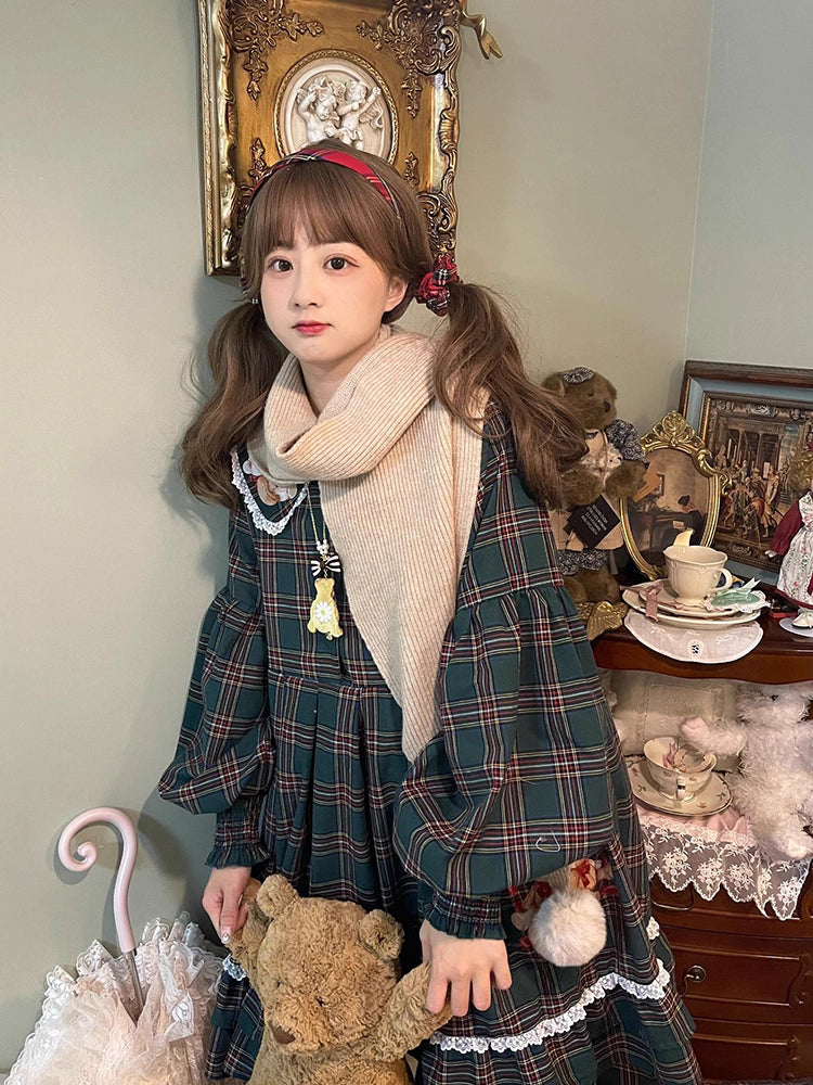 Inspired by festive nostalgia and childhood charm, this dress blends classic Christmas colors with a playful doll collar and soft plaid fabric. The A-line silhouette and delicate details evoke a storybook sweetness, while the cozy construction ensures comfort for holiday gatherings. A delightful piece that captures the magic of the season with timeless innocence and warmth.