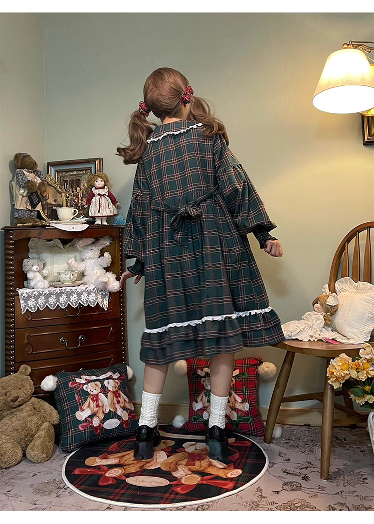 Inspired by festive nostalgia and childhood charm, this dress blends classic Christmas colors with a playful doll collar and soft plaid fabric. The A-line silhouette and delicate details evoke a storybook sweetness, while the cozy construction ensures comfort for holiday gatherings. A delightful piece that captures the magic of the season with timeless innocence and warmth.