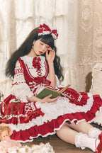 This Red White Sweet Lolita JSK Dress features a charming sleeveless design paired with a delicate cardigan for versatile layering. Multi layered ruffles and lace trims create a soft voluminous silhouette while bowknot details enhance its playful sweetness. The bold red and pure white contrast offers a festive yet elegant look making it perfect for tea parties holiday gatherings or themed occasions. Designed for comfort and style this set captures the essence of youthful Lolita fashion with timeless charm.