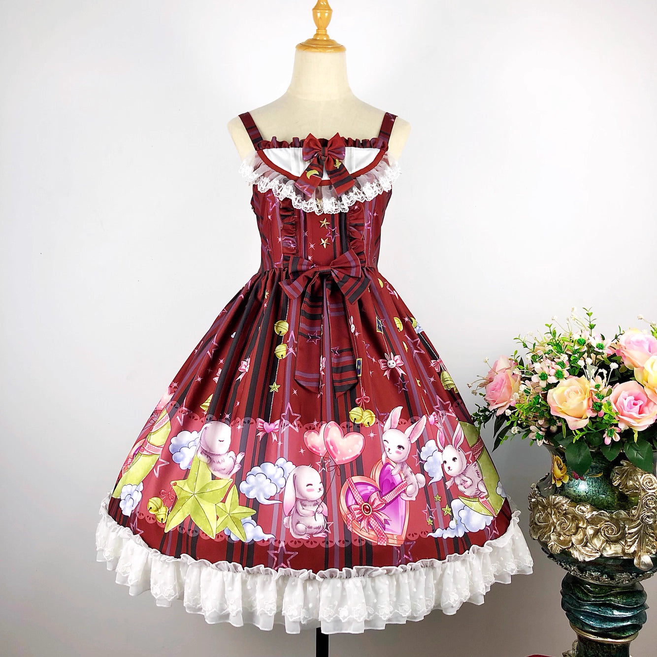 Inspired by a celestial carnival, this "Star Paradise" JSK features vibrant red printed fabric and playful bow accents. The strapless design and A-line silhouette offer a flattering fit for daily wear. Sweet yet versatile, it combines whimsical charm with wearable elegance, perfect for creating joyful coordinates that capture the magic of a starlit fantasy.