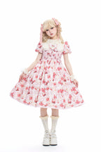 Enchanted by rustic witchcraft and sweet folklore, this pink dress blooms with delicate strawberry embroidery and whimsical prints. The sleeveless design and lightweight cotton ensure cool comfort for summer, while layered ruffles and a fitted waist balance playful charm with elegant structure. A spellbinding piece that captures the magic of sun-ripened berries and pastoral daydreams.