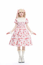 Enchanted by rustic witchcraft and sweet folklore, this pink dress blooms with delicate strawberry embroidery and whimsical prints. The sleeveless design and lightweight cotton ensure cool comfort for summer, while layered ruffles and a fitted waist balance playful charm with elegant structure. A spellbinding piece that captures the magic of sun-ripened berries and pastoral daydreams.