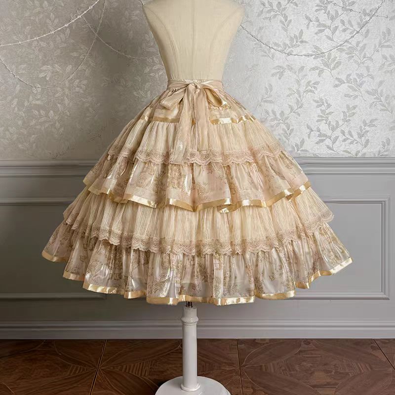 Enter a realm of opulent fantasy with the Twin Bears Gilded Dream skirt, where artistry meets elegance. This original design features exquisite golden embroidery shimmering against a luxurious fabric backdrop, evoking the magic of a twilight dream. The A-line silhouette flows gracefully, adorned with intricate details that catch the light with every movement. Perfect for enchanting tea parties, romantic gatherings, or adding a touch of grandeur to daily wear. Each stitch tells a story of craftsmanship and w