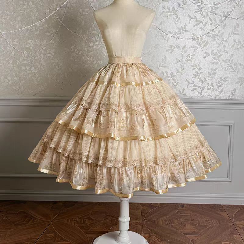 Enter a realm of opulent fantasy with the Twin Bears Gilded Dream skirt, where artistry meets elegance. This original design features exquisite golden embroidery shimmering against a luxurious fabric backdrop, evoking the magic of a twilight dream. The A-line silhouette flows gracefully, adorned with intricate details that catch the light with every movement. Perfect for enchanting tea parties, romantic gatherings, or adding a touch of grandeur to daily wear. Each stitch tells a story of craftsmanship and w