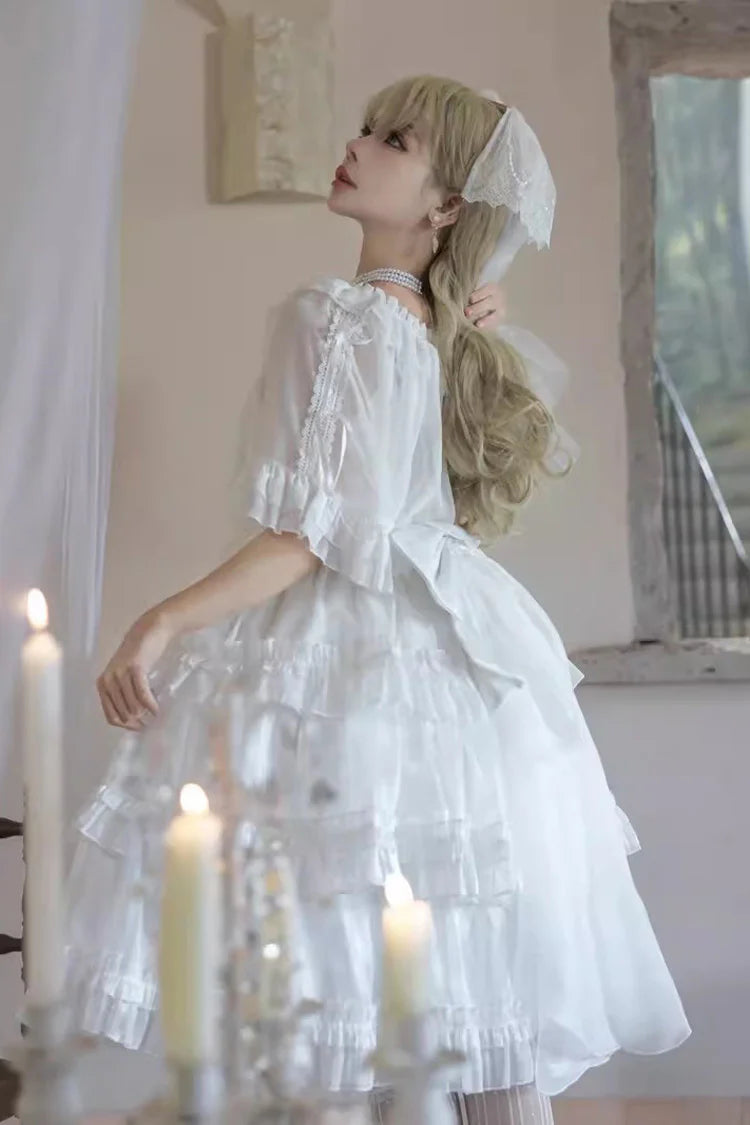 The Wedding Lolita White Starry Romance JSK Dress is created to blend bridal elegance with the dreamy sweetness of Lolita fashion. Crafted in pure white, it features multi-layered ruffles, graceful bow accents, and subtle starry details that evoke a fairytale atmosphere. The princess silhouette conveys both purity and sophistication, making it perfect for special ceremonies, photoshoots, or romantic occasions. Designed to capture timeless beauty, it offers a harmonious balance of sweetness, refinement, and 