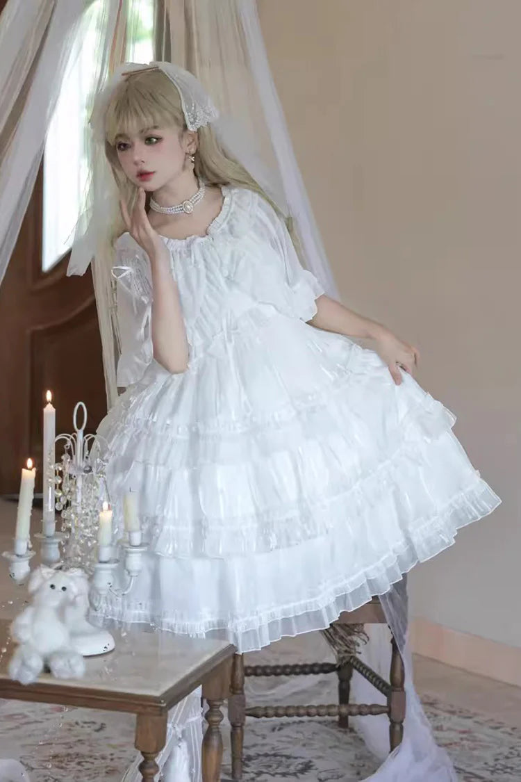 The Wedding Lolita White Starry Romance JSK Dress is created to blend bridal elegance with the dreamy sweetness of Lolita fashion. Crafted in pure white, it features multi-layered ruffles, graceful bow accents, and subtle starry details that evoke a fairytale atmosphere. The princess silhouette conveys both purity and sophistication, making it perfect for special ceremonies, photoshoots, or romantic occasions. Designed to capture timeless beauty, it offers a harmonious balance of sweetness, refinement, and 
