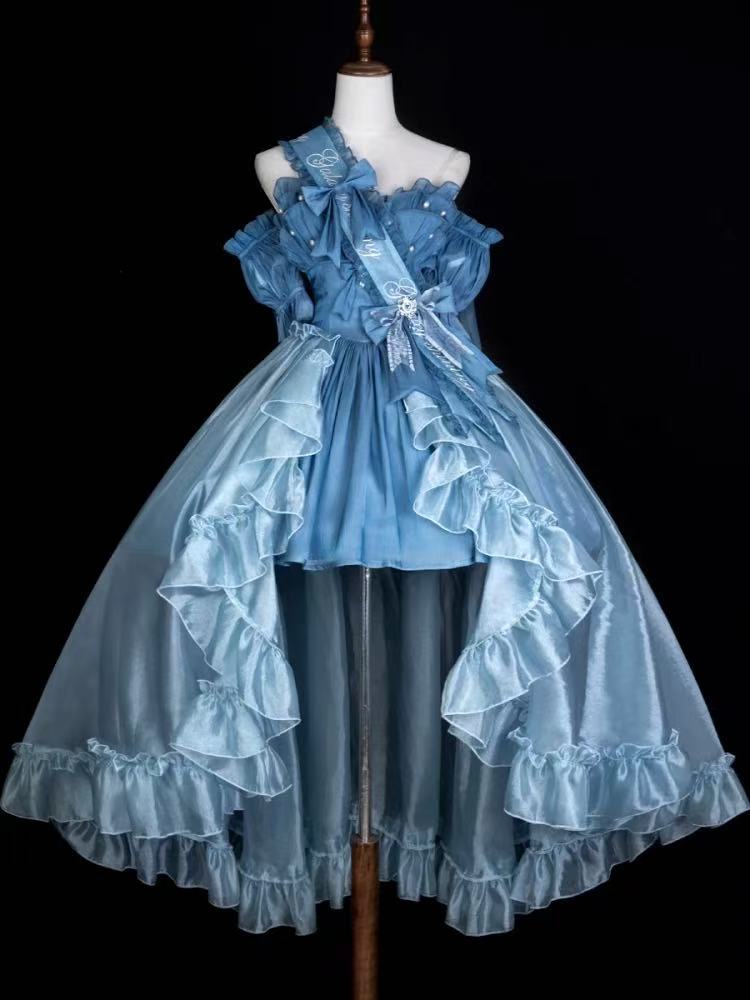 Design Concept:

This Classic Lolita charming blue dress set features delicate lace trim and bow details, combining elegance with a cute and refined style. The soft blue tone adds a graceful touch, perfect for creating a timeless Lolita look. Product Details: The set includes a dress, matching wrist sleeves, and a ribbon sash, offering a coordinated ensemble that embodies classic Lolita charm.