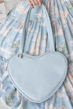 Design Concept:

This charming Lolita crossbody bag combines simplicity with sweet, playful charm. Crafted with a solid color design and a cute heart accent, it adds a touch of feminine elegance to any outfit. The compact size makes it perfect for carrying essentials, while the adjustable strap ensures comfortable wear. Available in four delightful colors—blue, white, pink, and yellow—this bag complements a variety of Lolita styles, making it ideal for daily wear, tea parties, or casual outings.