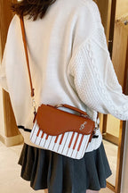 Design Concept:

This delightful Lolita crossbody bag combines musical charm with classic sweet style. Crafted with delicate piano note embroidery, it adds a whimsical and elegant touch to any outfit. The compact design makes it perfect for carrying essentials, while the adjustable strap ensures comfortable wear. Available in three versatile colors—black, pink, and brown—this bag complements a variety of Lolita coordinates, making it ideal for daily outings, music-themed events, or tea parties.