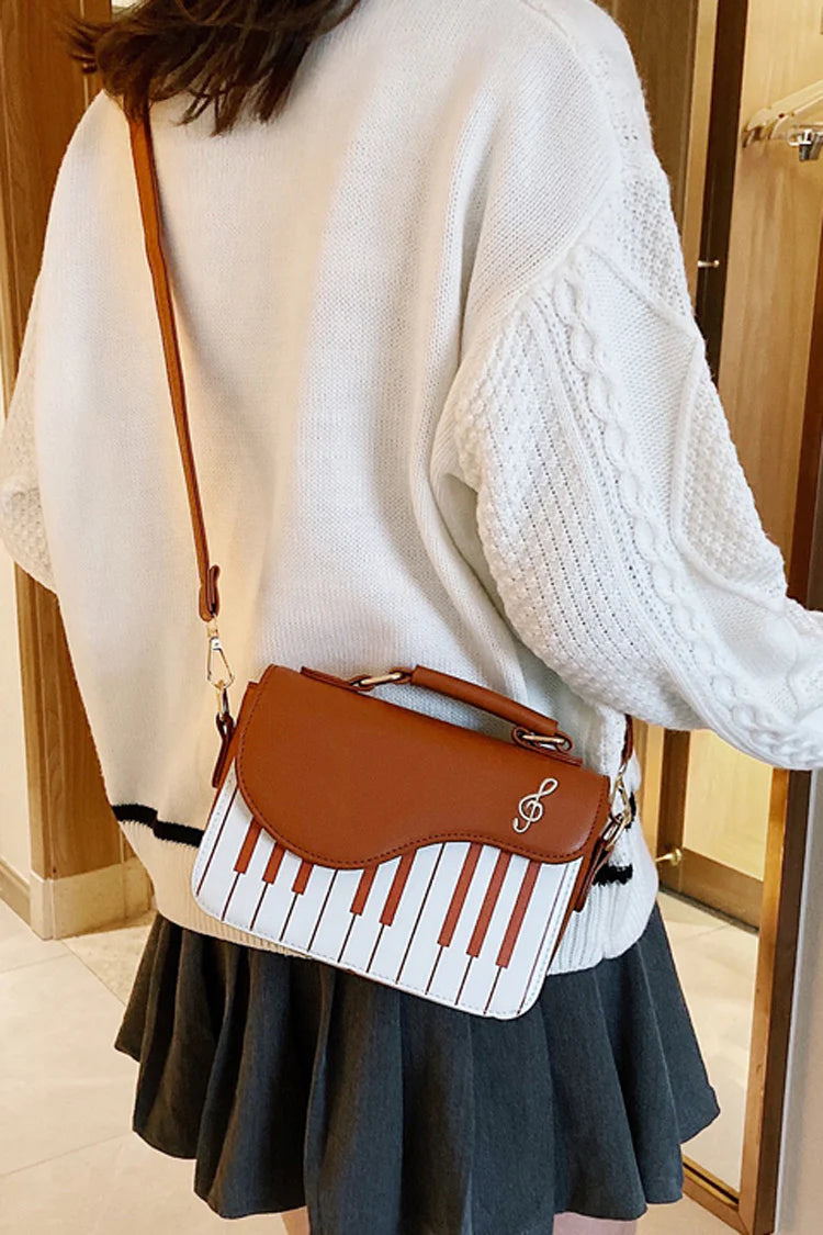 Design Concept:

This delightful Lolita crossbody bag combines musical charm with classic sweet style. Crafted with delicate piano note embroidery, it adds a whimsical and elegant touch to any outfit. The compact design makes it perfect for carrying essentials, while the adjustable strap ensures comfortable wear. Available in three versatile colors—black, pink, and brown—this bag complements a variety of Lolita coordinates, making it ideal for daily outings, music-themed events, or tea parties.