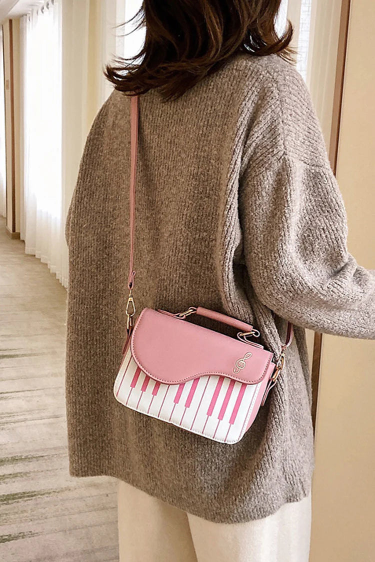 Design Concept:

This delightful Lolita crossbody bag combines musical charm with classic sweet style. Crafted with delicate piano note embroidery, it adds a whimsical and elegant touch to any outfit. The compact design makes it perfect for carrying essentials, while the adjustable strap ensures comfortable wear. Available in three versatile colors—black, pink, and brown—this bag complements a variety of Lolita coordinates, making it ideal for daily outings, music-themed events, or tea parties.