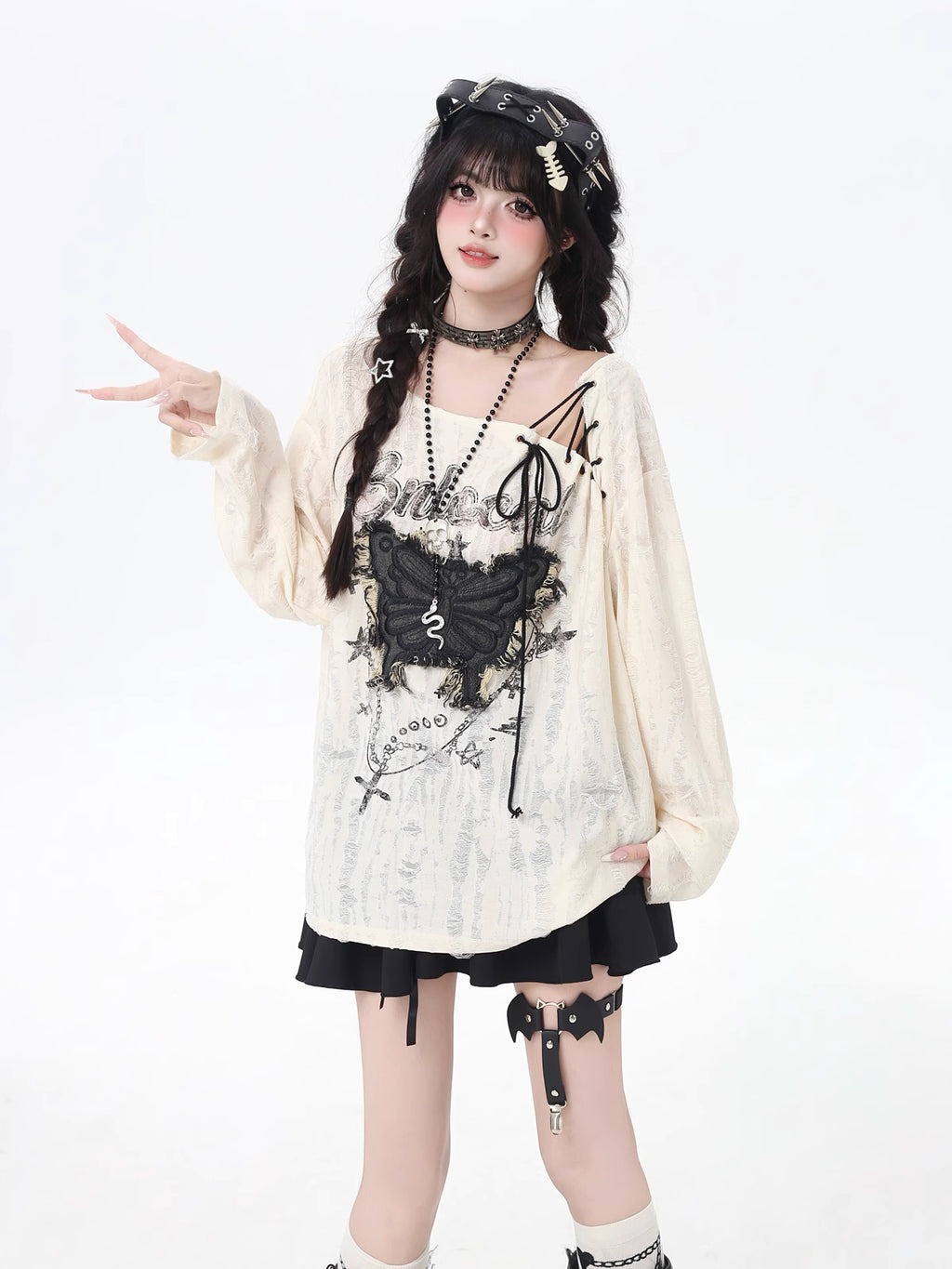 This apricot Lolita blouse blends retro sweetness with a touch of edgy design. Featuring delicate butterfly patch embellishments, distressed details, and lace-up accents, the piece captures both elegance and rebellious charm. The loose fit and long sleeves ensure a comfortable, effortless wear, perfect for early autumn layering. Ideal for casual outings or streetwear looks, this top adds a playful yet stylish twist to everyday fashion.