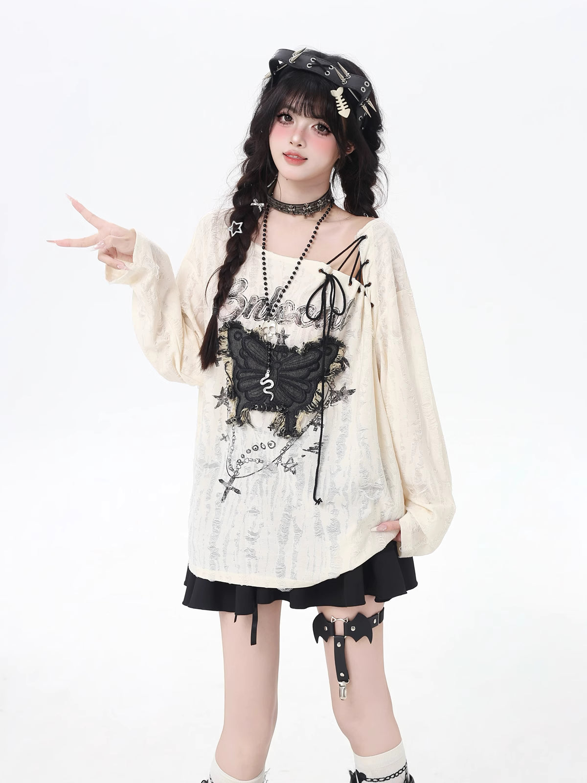 This apricot Lolita blouse blends retro sweetness with a touch of edgy design. Featuring delicate butterfly patch embellishments, distressed details, and lace-up accents, the piece captures both elegance and rebellious charm. The loose fit and long sleeves ensure a comfortable, effortless wear, perfect for early autumn layering. Ideal for casual outings or streetwear looks, this top adds a playful yet stylish twist to everyday fashion.