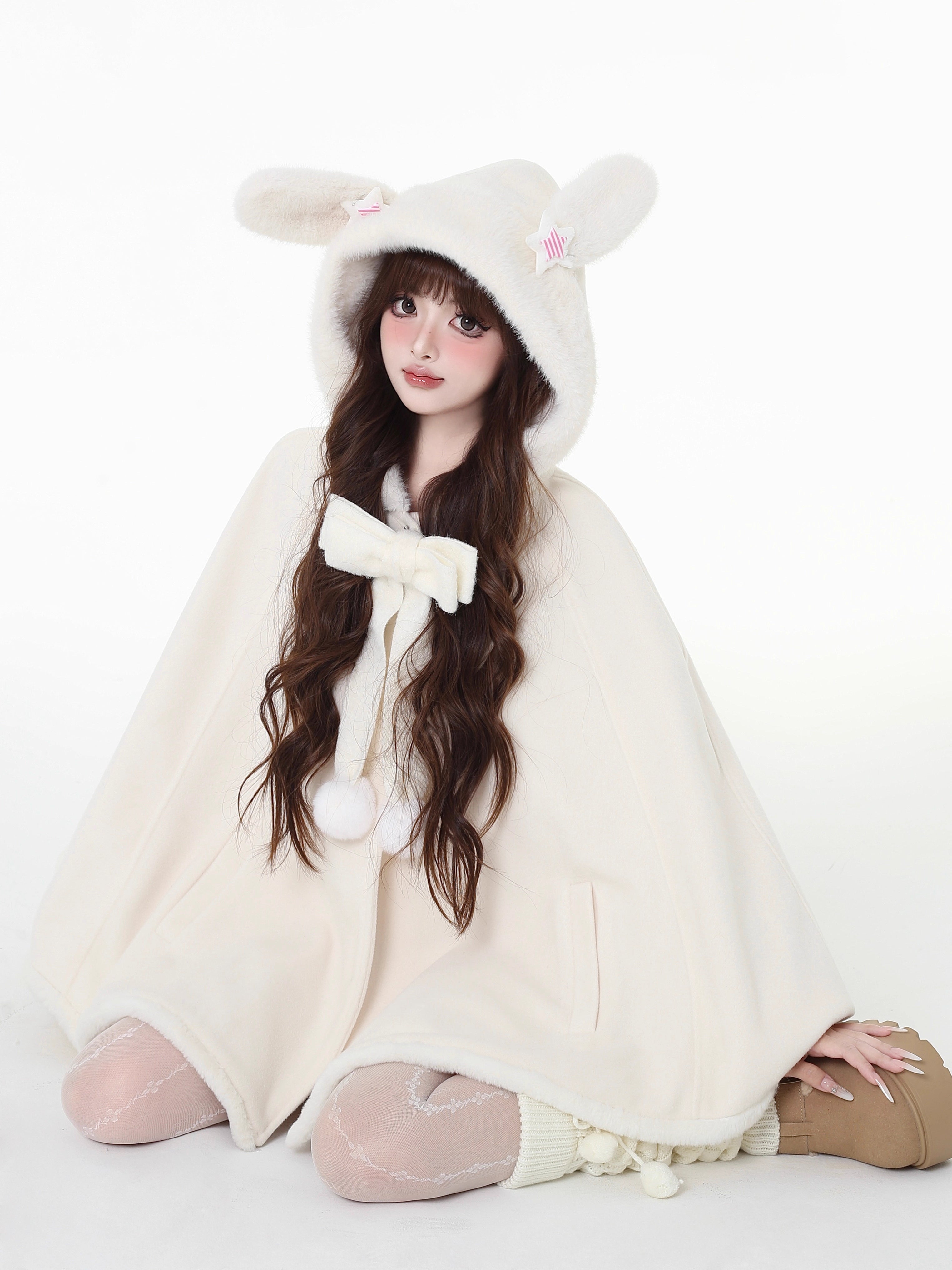 Design Concept:
This Light Apricot Lolita Coat features a charming bunny ear hood design, crafted from soft, high-quality wool for cozy warmth during winter. Designed in a loose-fit cape style, it allows for comfortable layering while maintaining a cute, playful aesthetic. The coat does not include a plush scarf, but comes with a removable decorative bow, adding an extra touch of sweet elegance to your outfit. Perfect for daily wear or casual outings in the colder months.