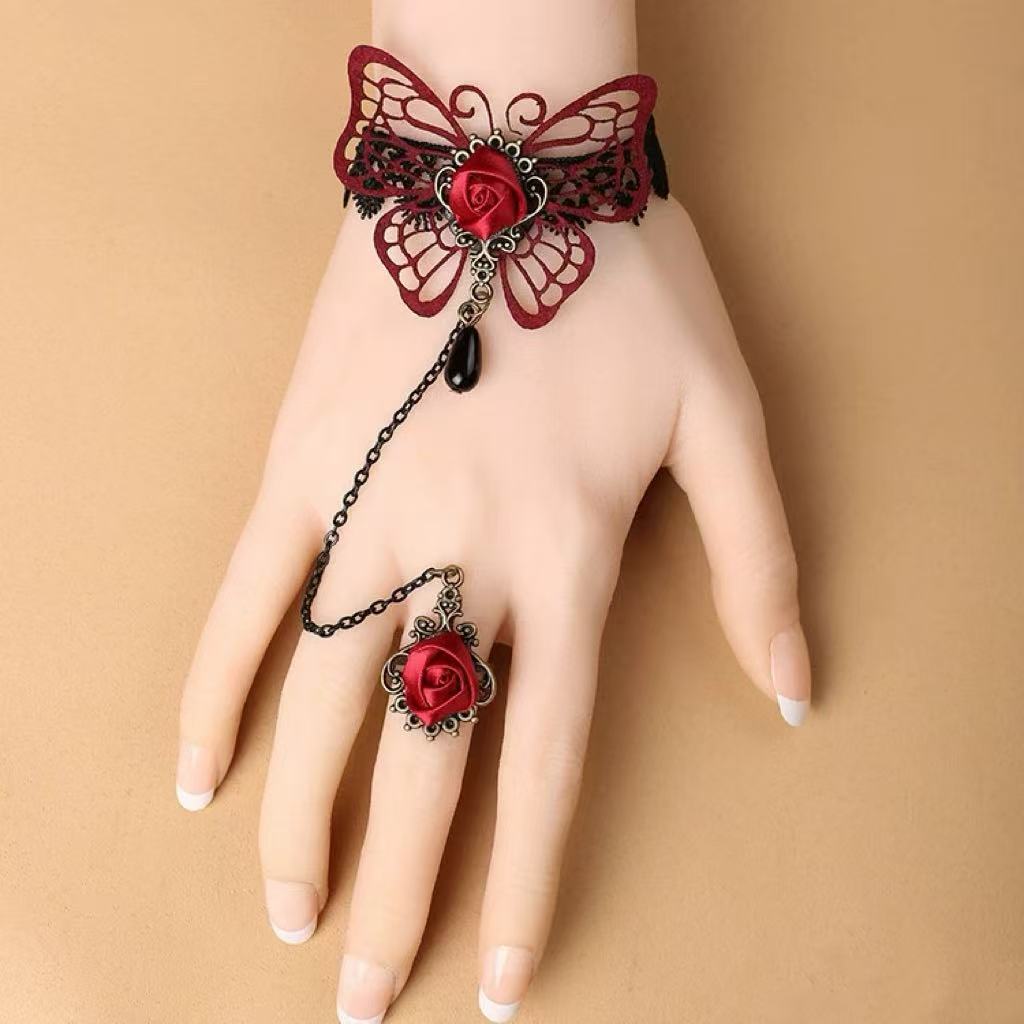 Design Concept:


Add a touch of dark romance to your coordinate with this wine red Gothic Lolita ring bracelet. Featuring delicate lace and an elegant butterfly motif, it combines vintage charm with mysterious allure. The integrated bracelet and ring design creates a graceful silhouette that highlights the hand with intricate detail. Perfect for cosplay, themed events, tea parties, or daily Gothic Lolita styling, this accessory brings a dramatic yet refined finish to your look.