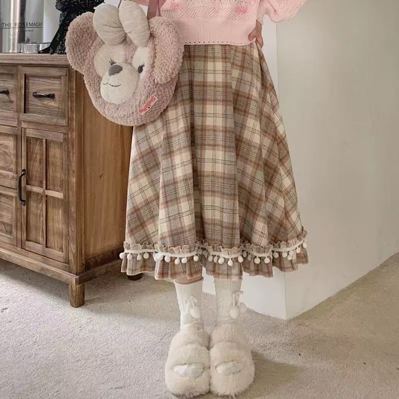 Design Concept:
This vintage-inspired Lolita skirt in a classic plaid wool fabric captures both warmth and elegance. The playful pom-pom accents add a unique touch of charm, while the flattering high-waist A-line cut creates a graceful silhouette. Perfect for daily wear or winter gatherings, the skirt blends retro details with cozy textures, making it an essential piece for an elegant Lolita wardrobe.