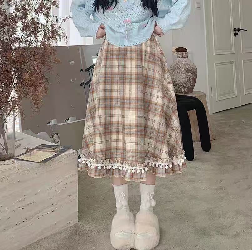 Design Concept:
This vintage-inspired Lolita skirt in a classic plaid wool fabric captures both warmth and elegance. The playful pom-pom accents add a unique touch of charm, while the flattering high-waist A-line cut creates a graceful silhouette. Perfect for daily wear or winter gatherings, the skirt blends retro details with cozy textures, making it an essential piece for an elegant Lolita wardrobe.