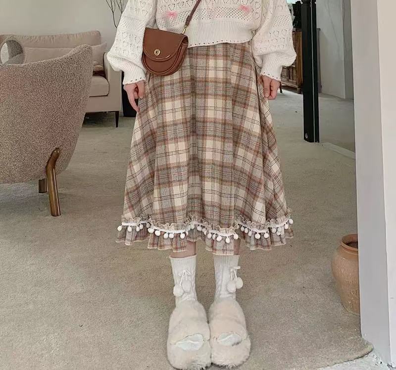 Design Concept:
This vintage-inspired Lolita skirt in a classic plaid wool fabric captures both warmth and elegance. The playful pom-pom accents add a unique touch of charm, while the flattering high-waist A-line cut creates a graceful silhouette. Perfect for daily wear or winter gatherings, the skirt blends retro details with cozy textures, making it an essential piece for an elegant Lolita wardrobe.