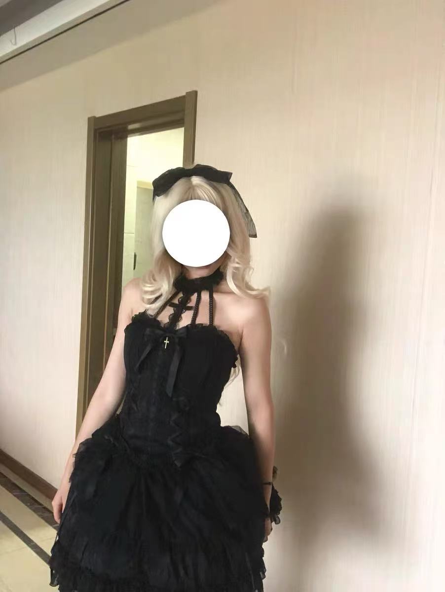 This Sweet Lolita dress in soft pink features a strapless, sleeveless design adorned with a charming bow and delicate frill detailing. The layered skirt adds volume and a playful, sweet aesthetic, creating a feminine Lolita silhouette. Perfect for daily wear, cosplay, or special occasions, this dress combines whimsical charm with elegant style.