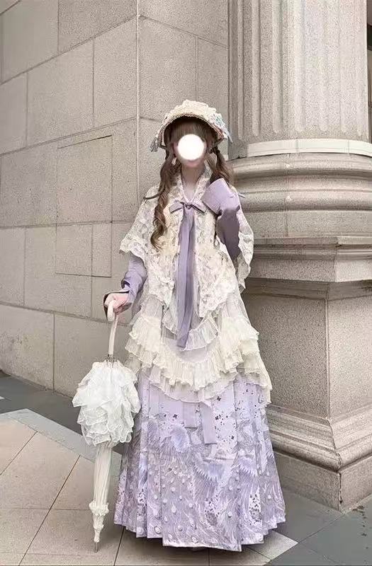 Design Concept:

This Sweet Lolita purple cross collar cardigan dress set blends soft elegance with delicate lace trim, creating a charming and refined Lolita look. The combination of purple and beige tones adds a gentle contrast, enhancing the outfit’s visual appeal. Product Details: The set includes a purple blouse, a beige shawl, a beige skirt overlay, and a matching mamian skirt, offering a complete coordinated ensemble perfect for Lolita fashion.