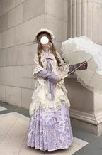 Design Concept:

This Sweet Lolita purple cross collar cardigan dress set blends soft elegance with delicate lace trim, creating a charming and refined Lolita look. The combination of purple and beige tones adds a gentle contrast, enhancing the outfit’s visual appeal. Product Details: The set includes a purple blouse, a beige shawl, a beige skirt overlay, and a matching mamian skirt, offering a complete coordinated ensemble perfect for Lolita fashion.