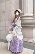 Design Concept:

This Sweet Lolita purple cross collar cardigan dress set blends soft elegance with delicate lace trim, creating a charming and refined Lolita look. The combination of purple and beige tones adds a gentle contrast, enhancing the outfit’s visual appeal. Product Details: The set includes a purple blouse, a beige shawl, a beige skirt overlay, and a matching mamian skirt, offering a complete coordinated ensemble perfect for Lolita fashion.