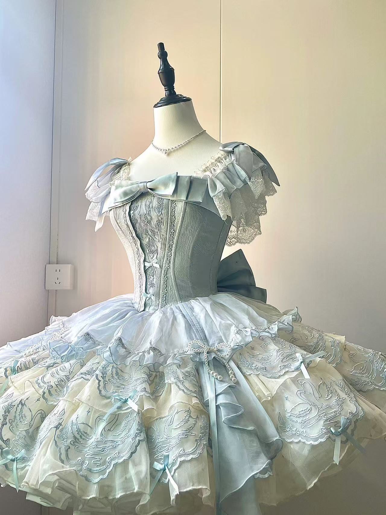 Design Concept:

This exquisite Sweet Lolita dress draws inspiration from classical ballet, featuring a delicate blue color scheme and intricate embroidery that creates an atmosphere of elegant sweetness. The dress comes with a beautifully crafted bow accent on the chest and includes a detachable train, adding a touch of princess-like grandeur to your ensemble. Made from high-quality tulle and cotton fabrics, the full skirt creates a lovely silhouette reminiscent of a ballerina's tutu, while the detailed em
