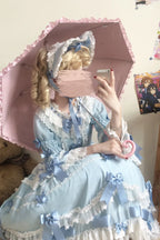 Design Concept:

This Sweet Lolita dress in soft blue features a round neck and long flared sleeves, adorned with delicate lace and a charming ribbon for a bridal-inspired princess look. The silhouette combines elegance with daily wearability, creating a sweet and graceful Lolita aesthetic. Perfect for special occasions, cosplay, or completing a feminine wardrobe, this dress highlights both sophistication and playful charm.