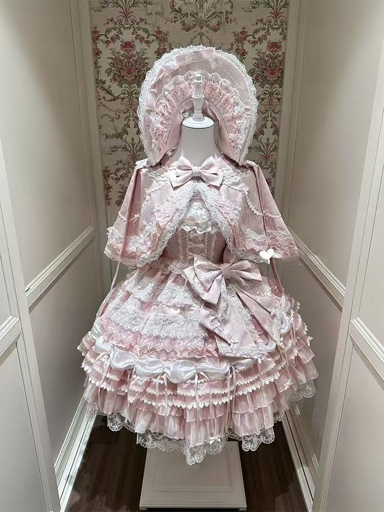 Design Concept:

This Sweet Lolita pink lace trimmed strappy JSK princess dress set embodies a delicate and charming style, combining soft pink tones with elegant lace details for a dreamy Lolita look. Product Details: The set includes a pink dress, a pin-on bow, an official matching inner petticoat, and a coordinating cape, creating a complete and enchanting outfit perfect for special occasions or Lolita fashion events.